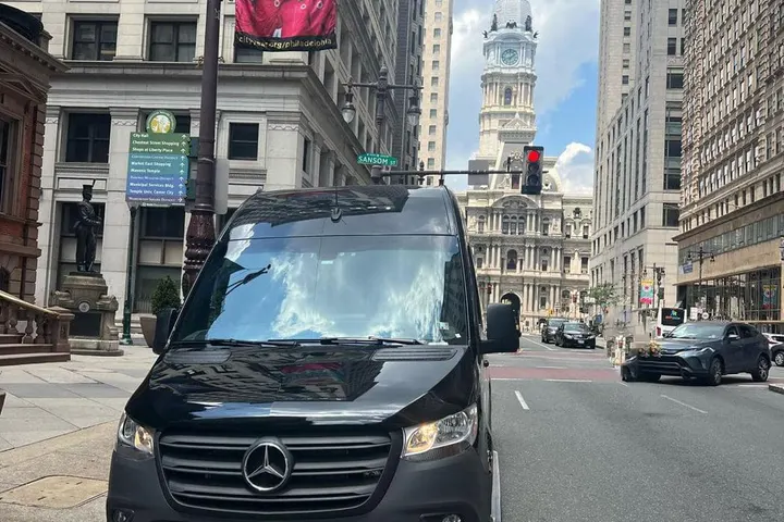 The Royal Limousine Mercedes-Benz Sprinter on a Philadelphia street with City Hall in the background